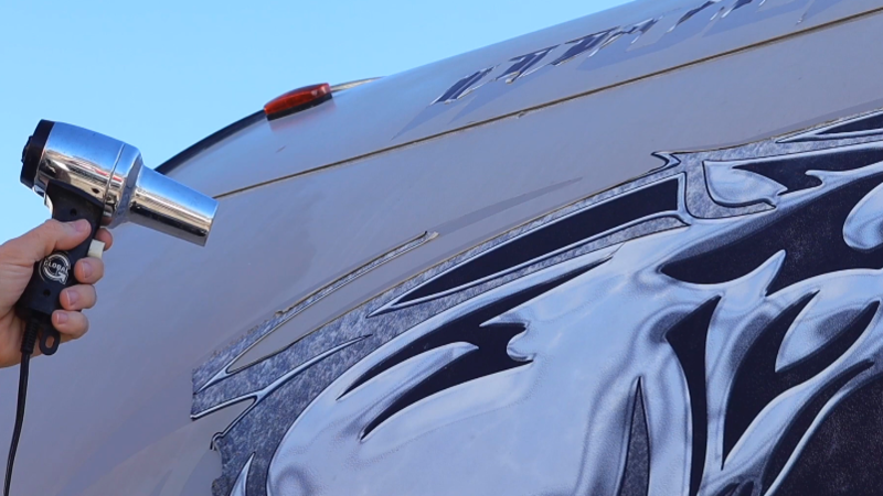 Using a heat gun to loosen the adhesive
