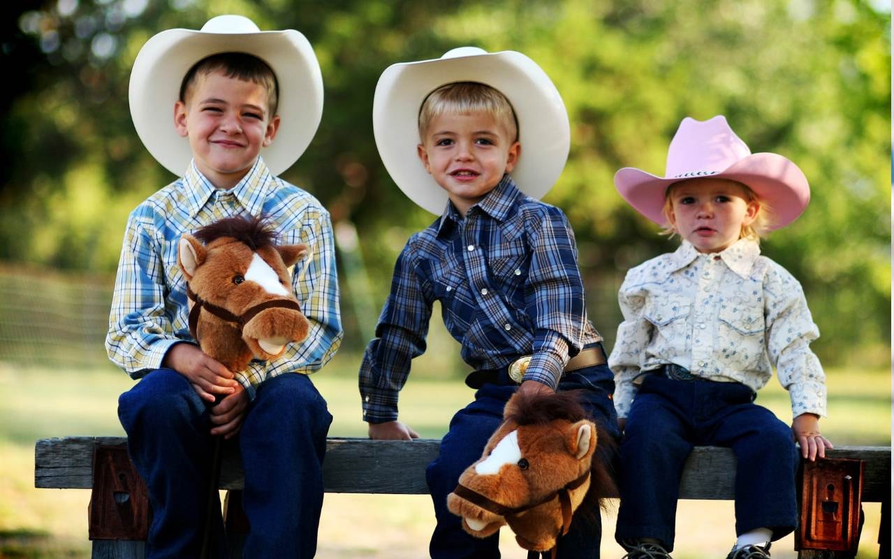 young children wearing cowboy hats