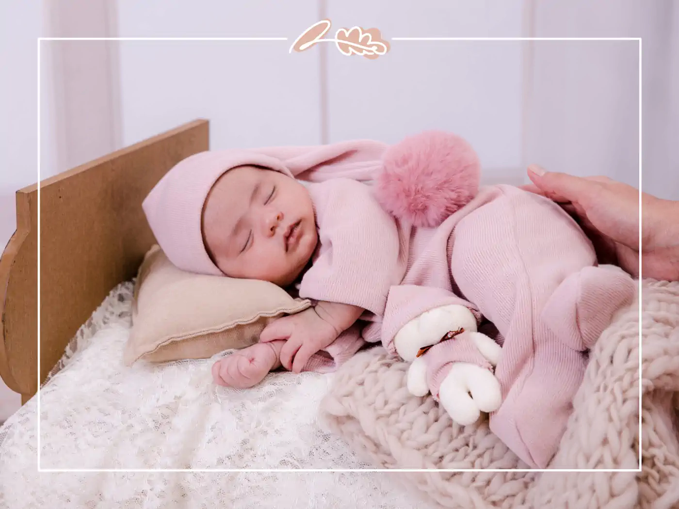 A peaceful baby dressed in a pink outfit, sleeping soundly with a small stuffed animal. Fabulous Flowers and Gifts.