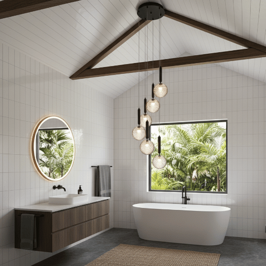 Vaulted bathroom with exposed beams and a cluster of globe pendant lights over a freestanding tub as bathroom ceiling lighting ideas.
