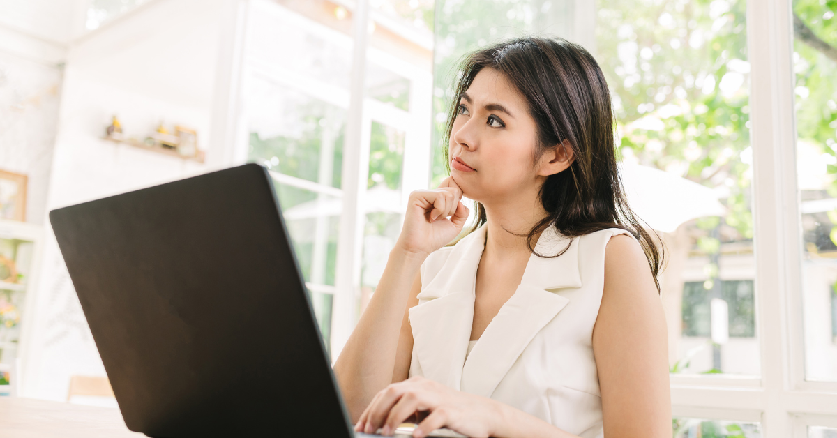 A woman reviewing financial documents, learning tax strategies for OnlyFans as a self-employed creator.
