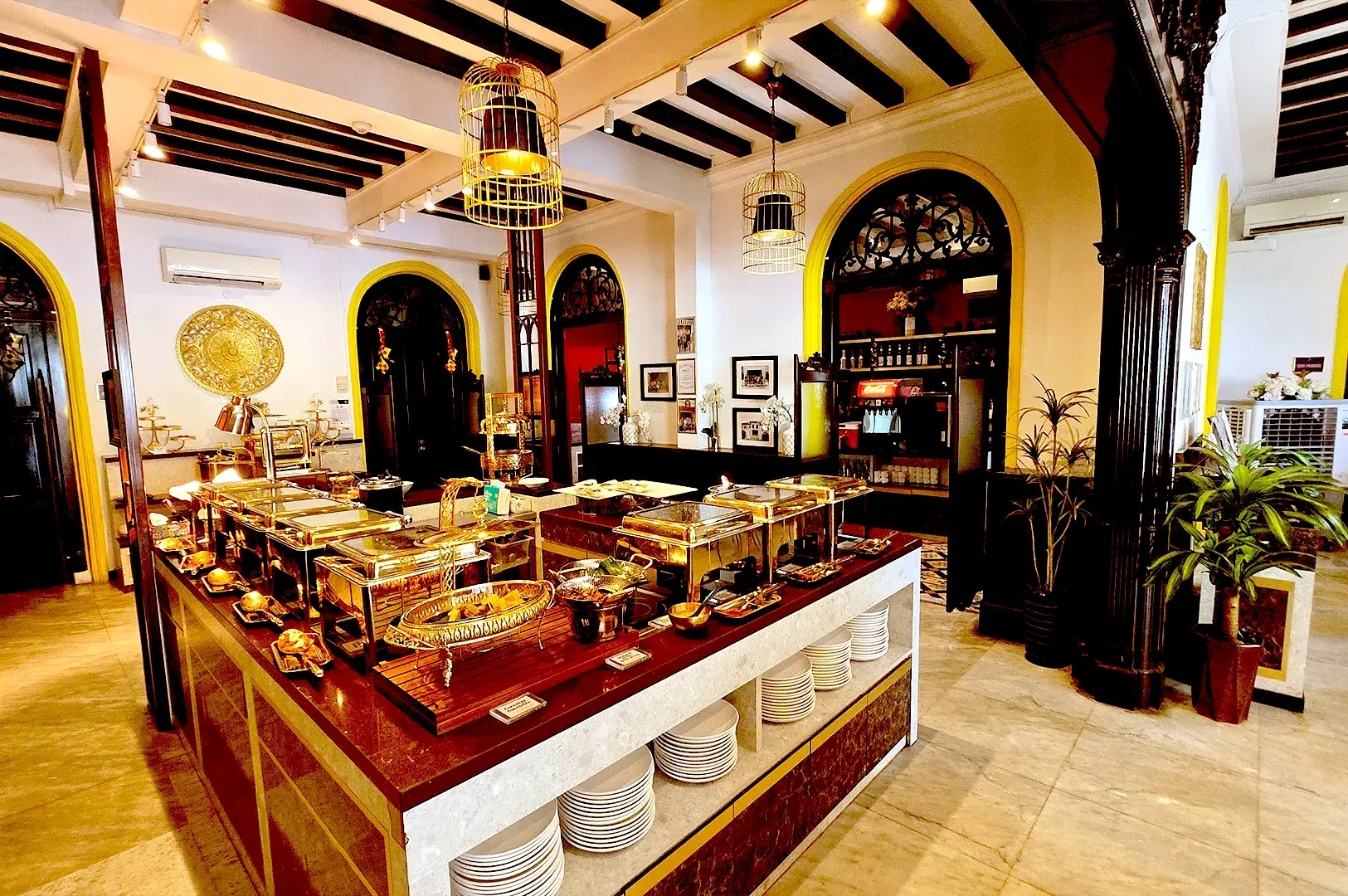 Elegant buffet dining setup at Permata Singapore, featuring an array of premium halal Nusantara dishes served in a sophisticated, heritage-inspired interior at the historic Gedung Kuning.
