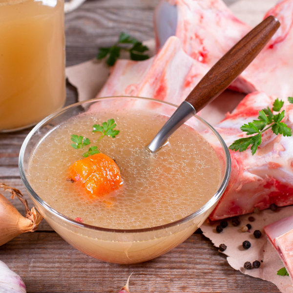 An image showing bone broth in a bowl, which supports the digestive system.