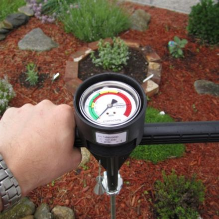A soil compaction tester being used to measure soil compaction