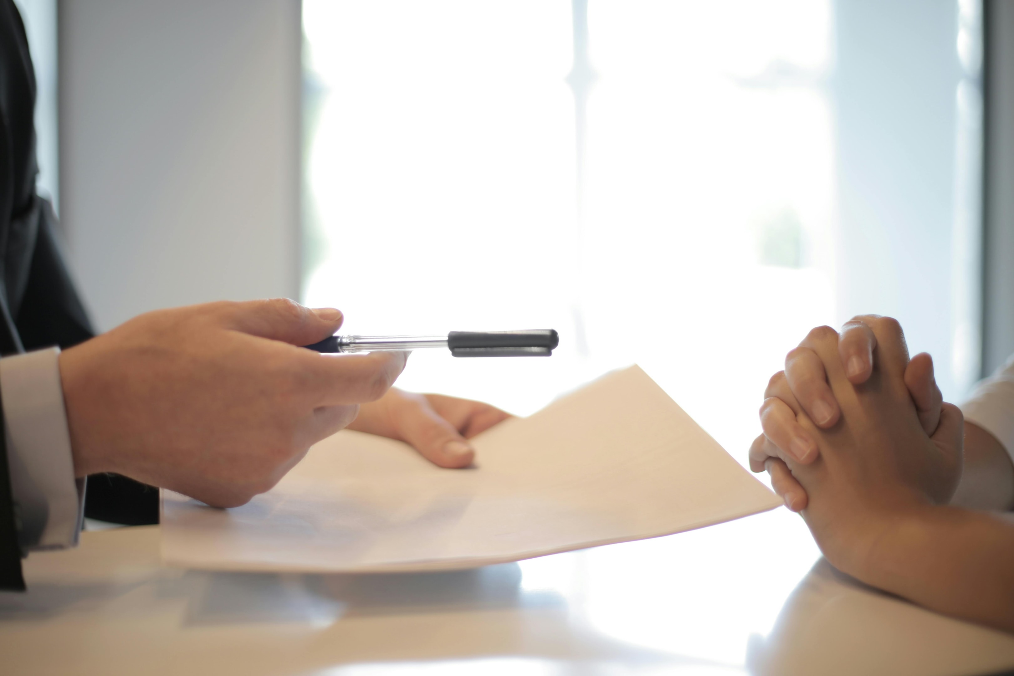 Real estate investor hands paperwork to heir of probate property.