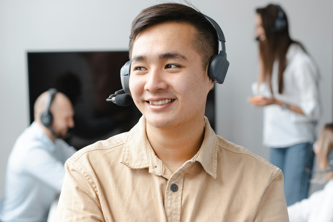 Filipino virtual assistant wearing a headset in a remote work setup