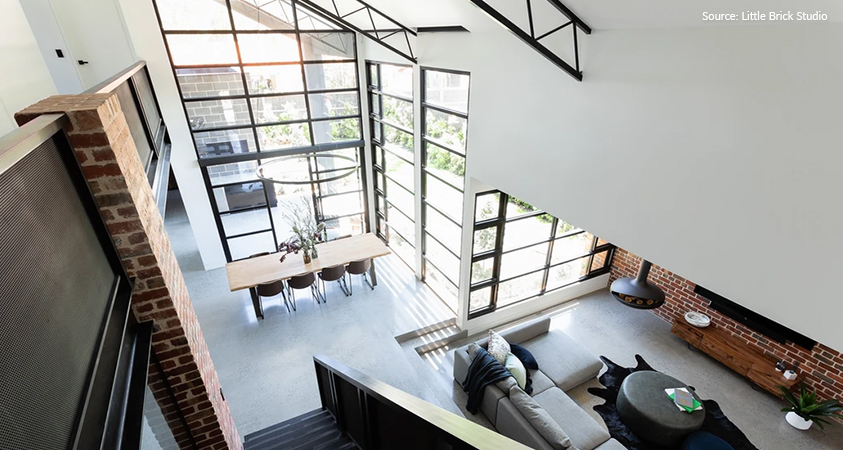 An industrial style living room as seen from the second floor. Picture sourced from The Little Brick Studio.