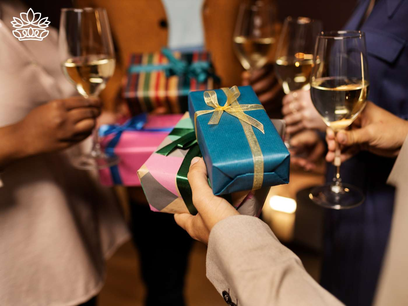 A group of people celebrating with gift boxes and glasses of wine, exchanging unique and personalized birthday gift boxes, including a gift hamper and a gift basket, showcasing great gifts with a personal touch for a perfect gift experience. Fabulous Flowers and Gifts.