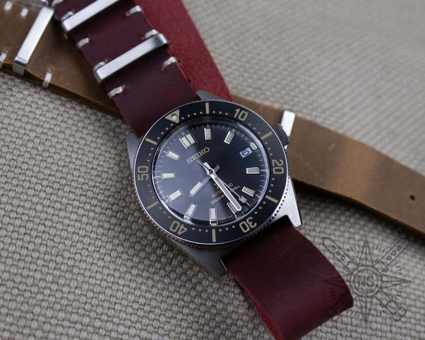 A classic red leather watch strap displayed elegantly.