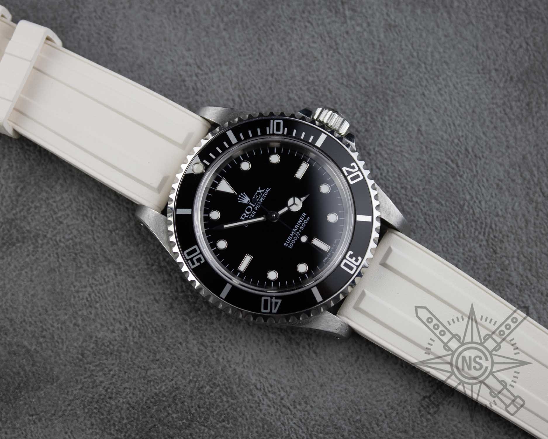 A close-up of a white rubber watch strap showcasing its texture and design.