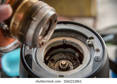 A flat Burr coffee grinder being cleaned