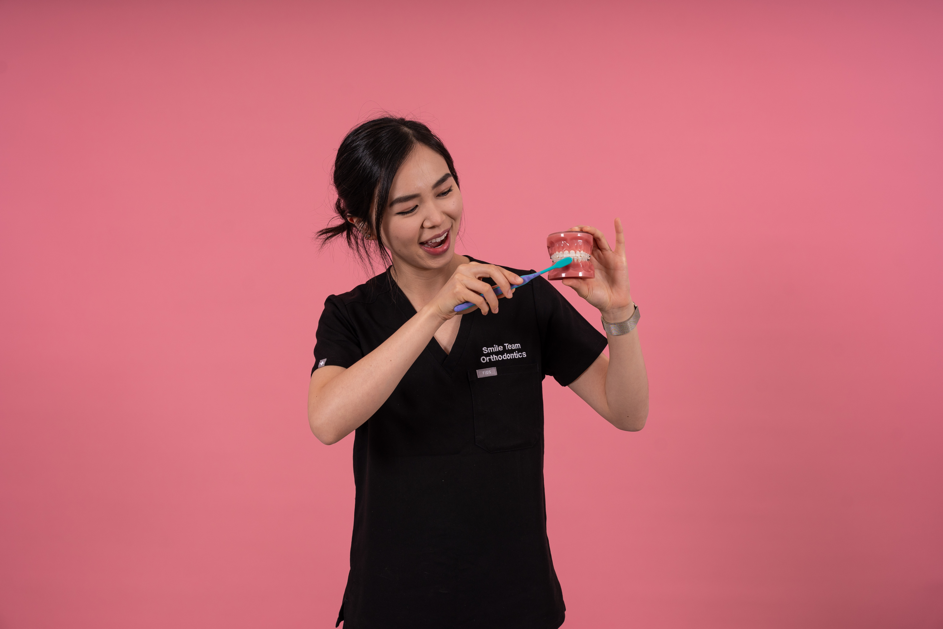 Dental nurses with dental model and toothbrush 