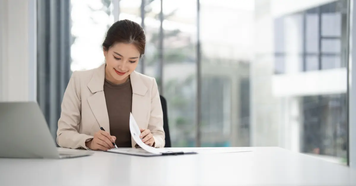 Female entrepreneur signing LLC resolution document for tax compliance and business protection.