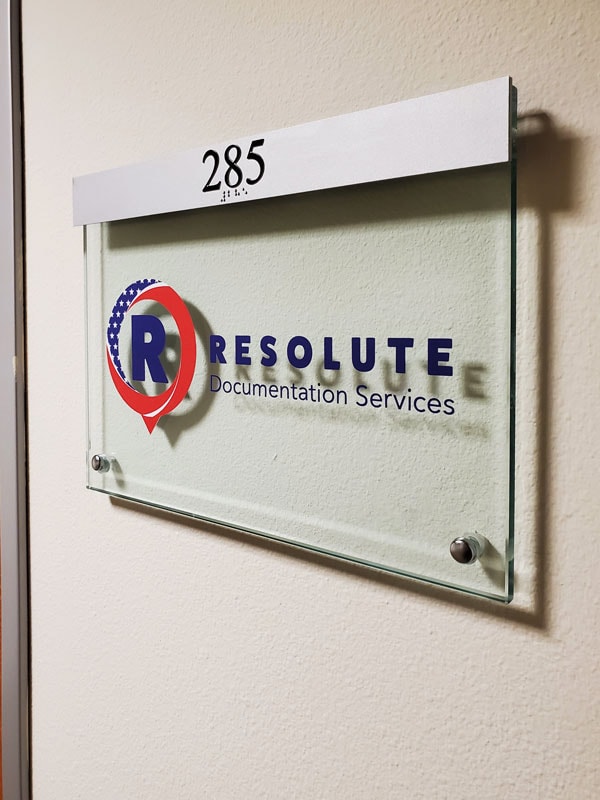 Resolute Documentation Services – We designed this ADA-compliant acrylic office suite sign as part of a series, meeting accessibility standards while giving their workspace a clean, professional look.