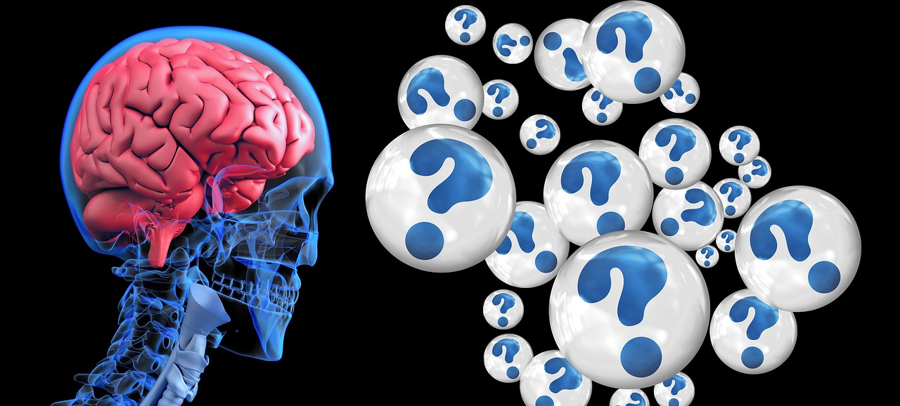A graphical image of a red brain in a human skeletal form looking at white balls with question marks inside symbolizing dementia.