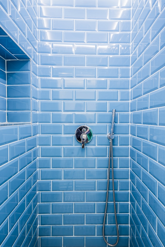 Shower walls with blue subway tile