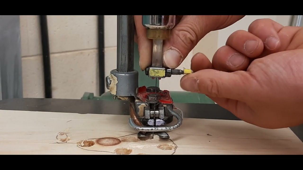 A scroll saw being set up with proper blade tension and speed for woodworking.