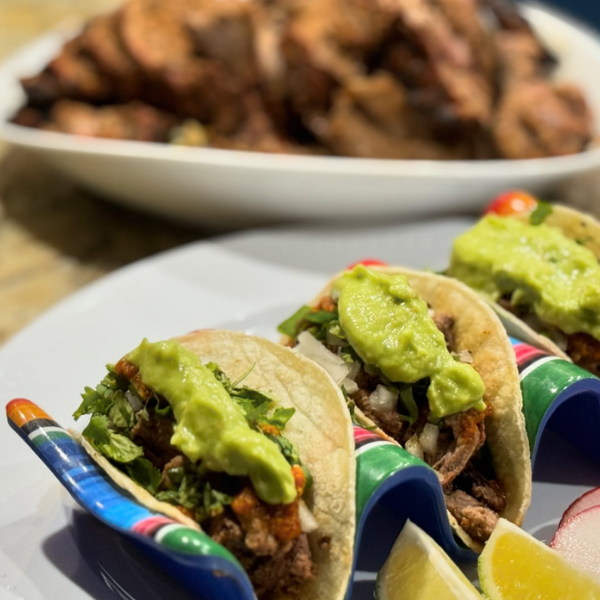 Picture of Roosters Rolling BBQ food truck serving tacos.