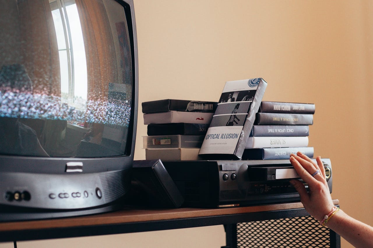 A past original media VHS tapes being played in a player.