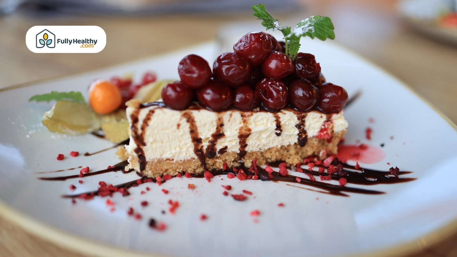 Cheesecake slice topped with cherries and chocolate drizzle on plate.