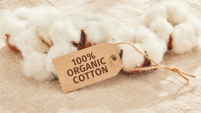 A bunch of organic cotton with a tag that says 100 % organic cotton