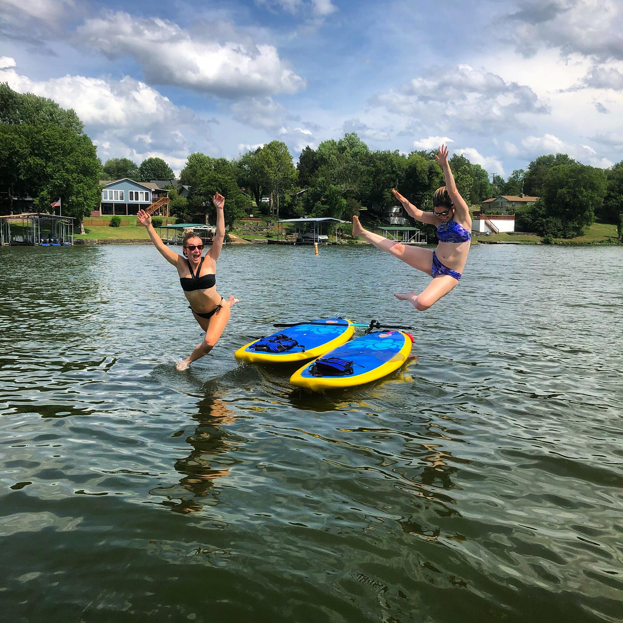 women falling off stand up paddle boards