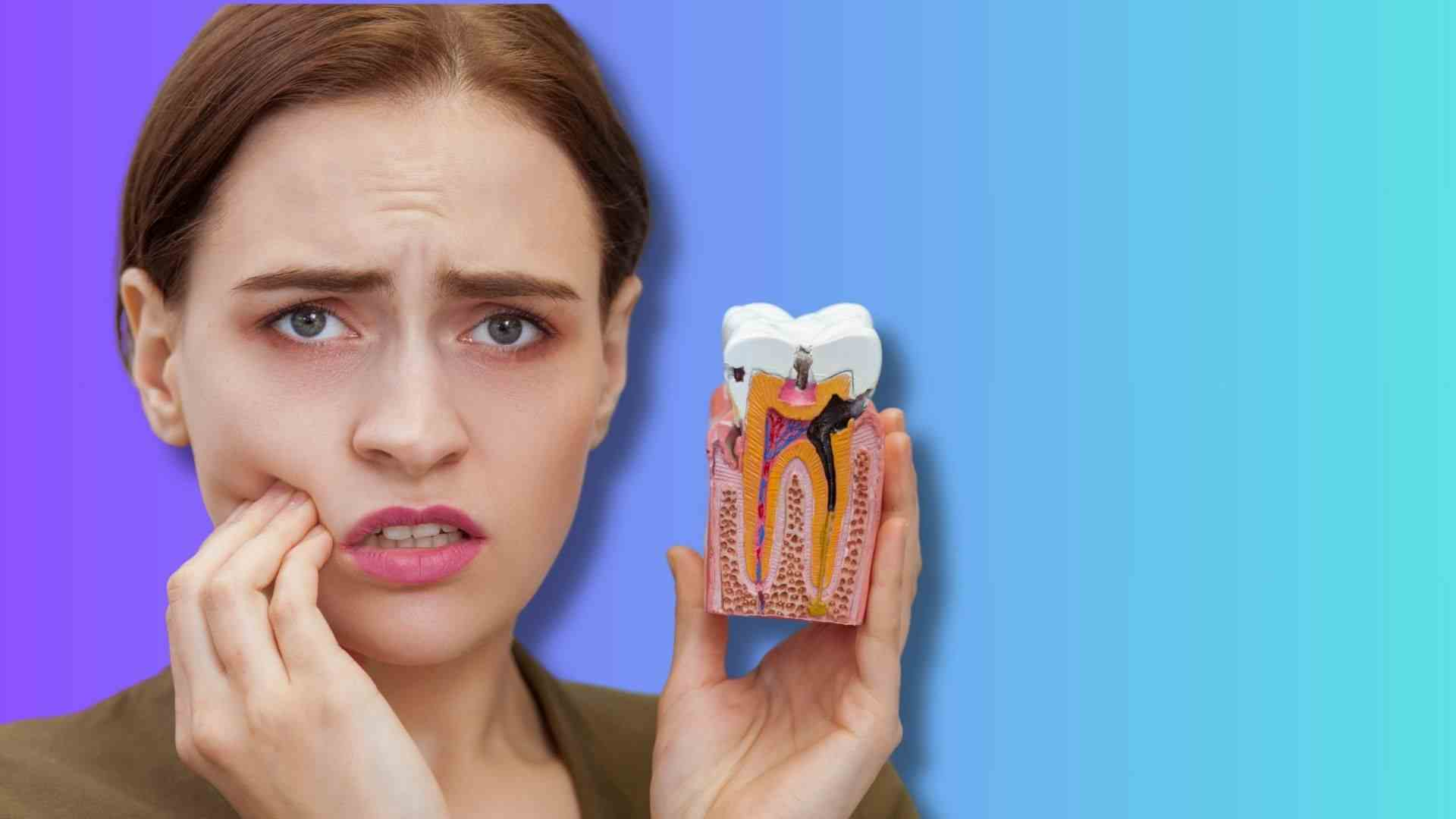 a woman showing tooth cavity model