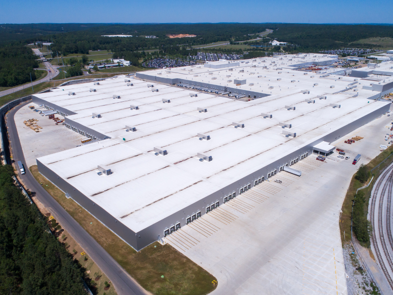 An image showing commercial roof coatings on a large warehouse in San Antonio. 