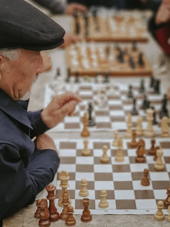 An older man playing chess