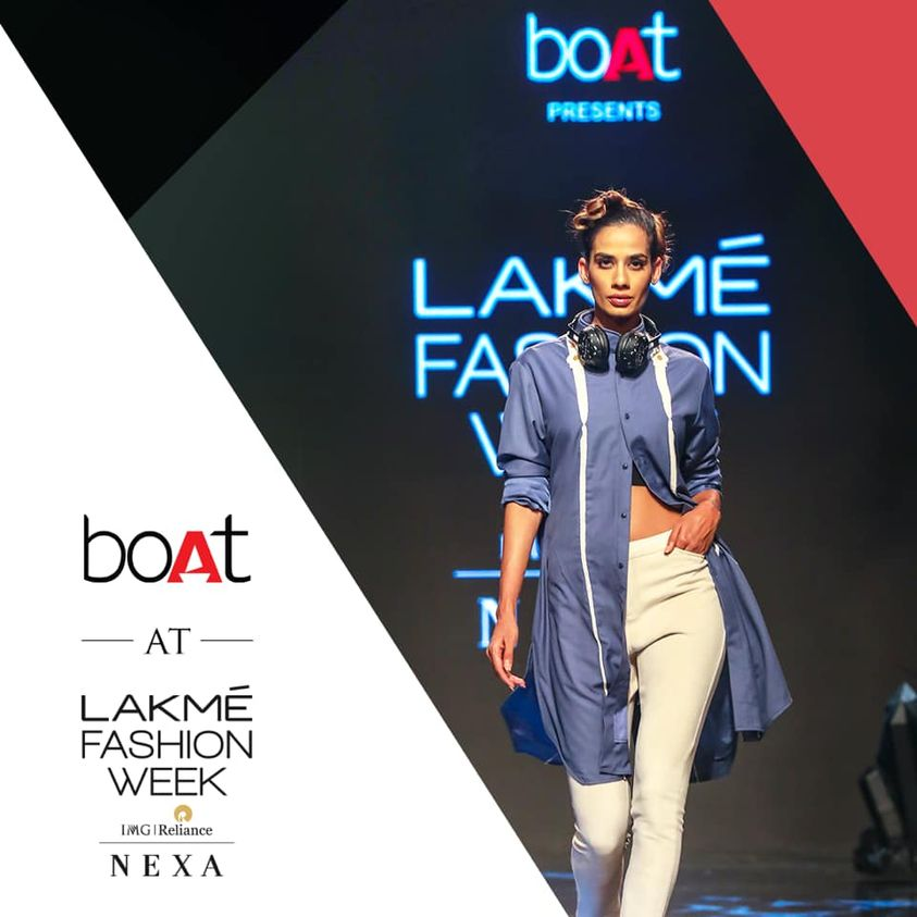 This image showcases a model walking on the ramp wearing boAt headphone on the Lakme fashion week show
