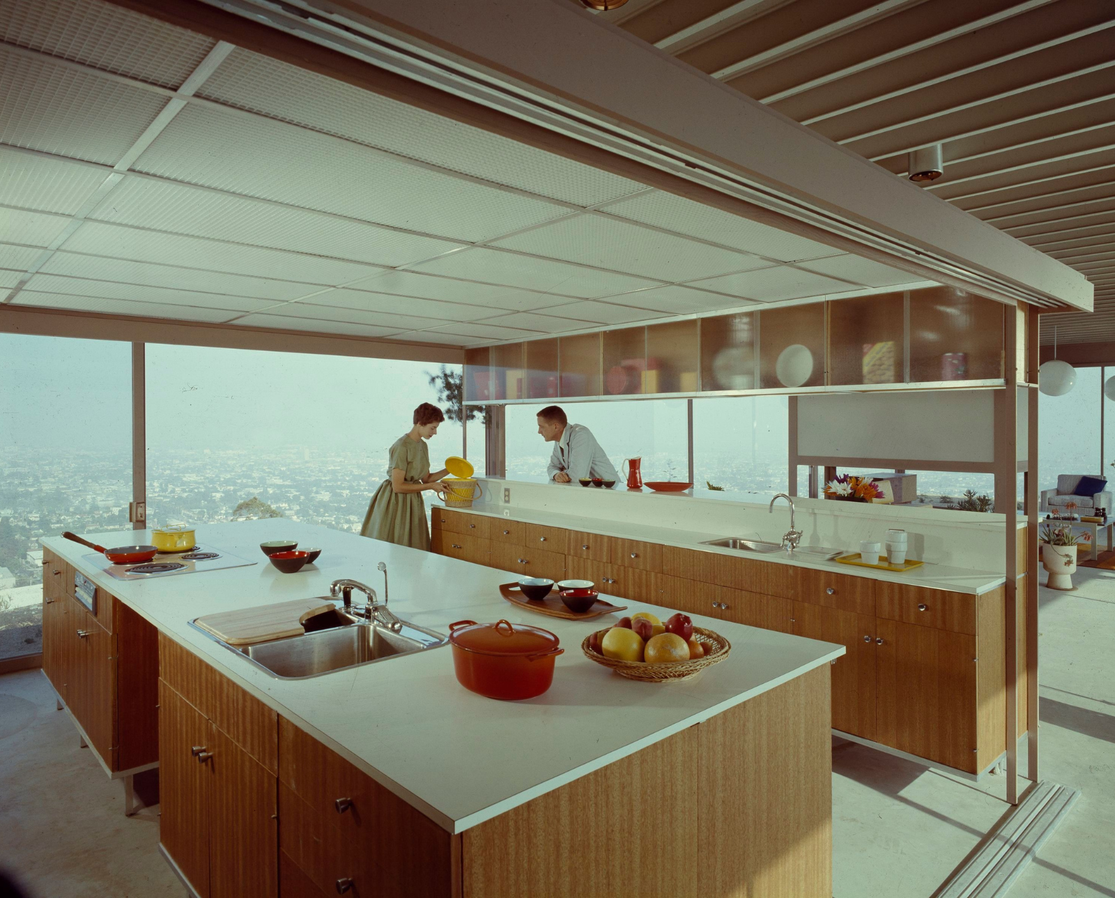 A photograph of the Southern California Stahl House kitchen staged with a man and a woman.