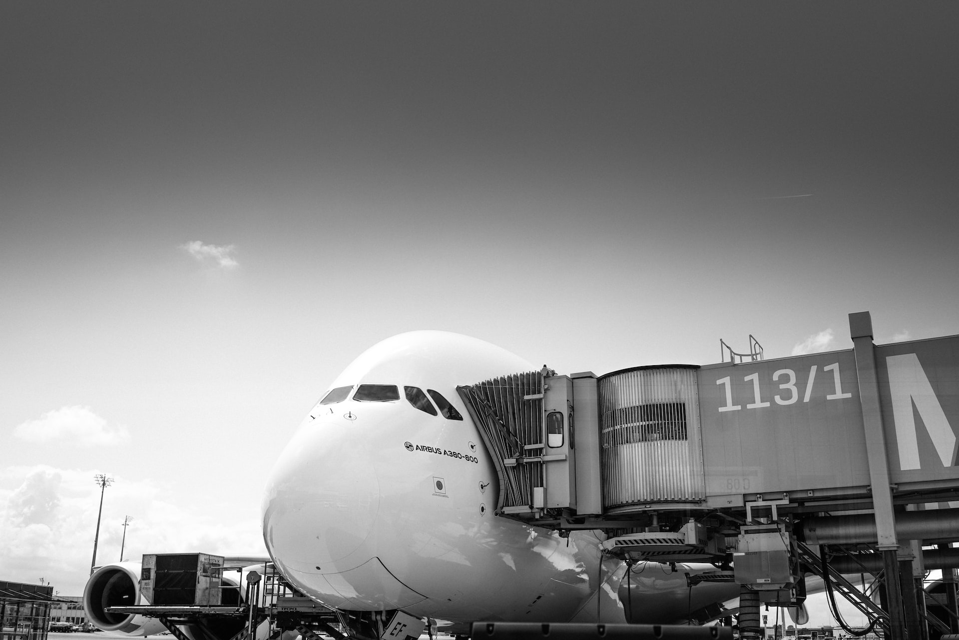 An Airbus A380 at a jetway waiting for passengers to board.