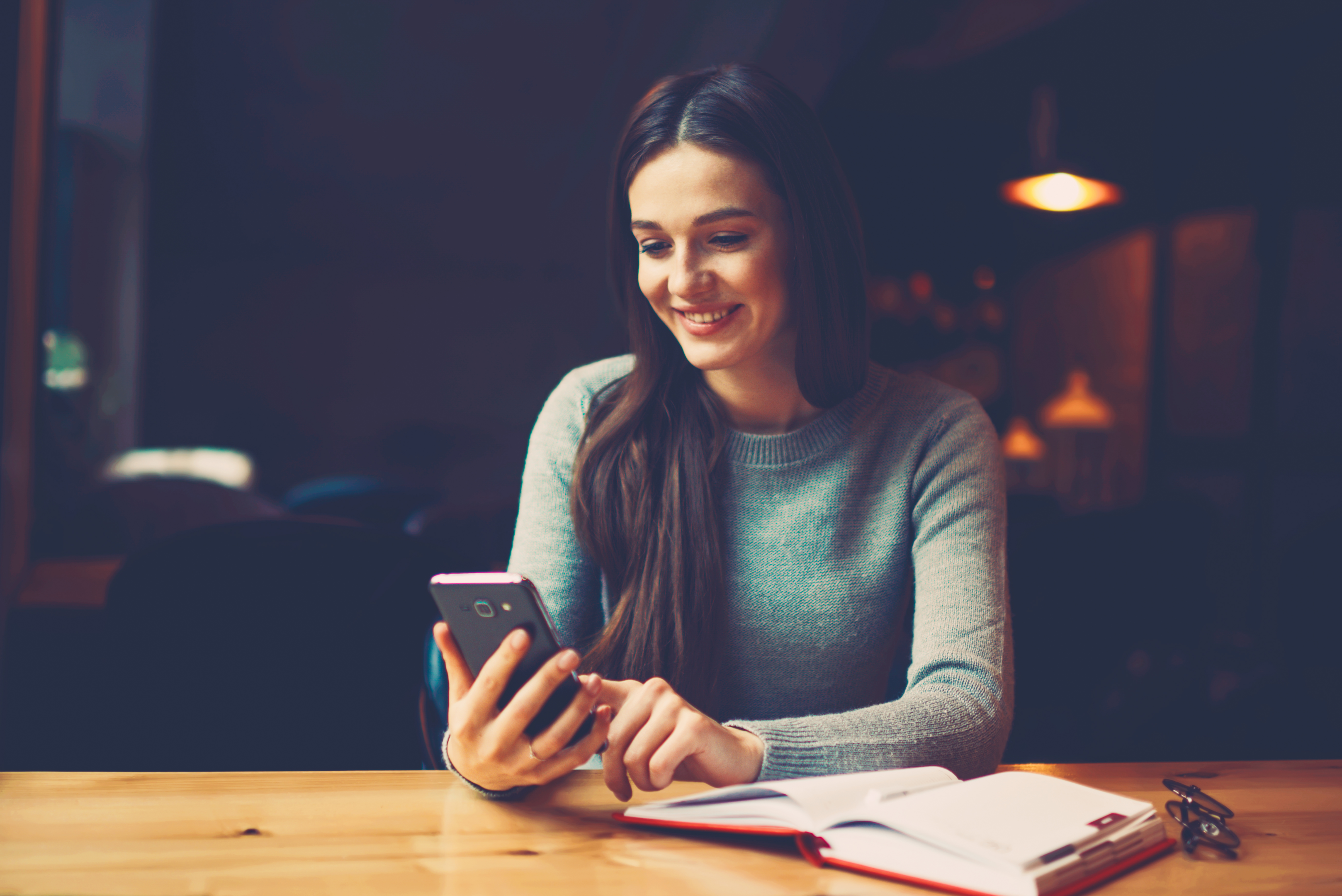 a woman searches online through her mobile phone