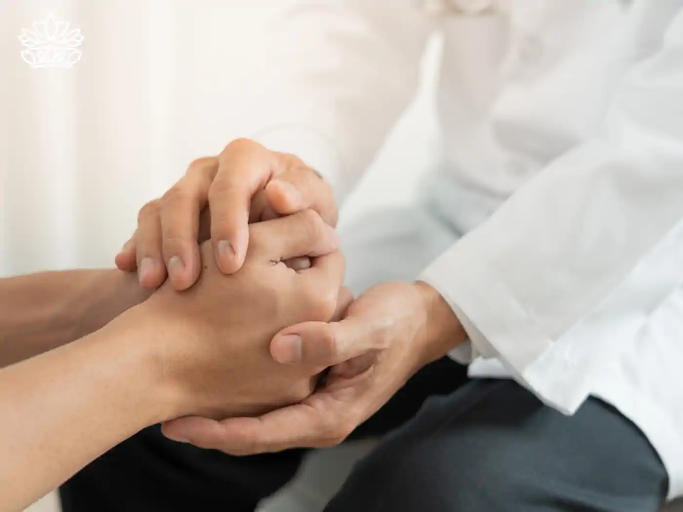 Close-up of a reassuring hand-holding gesture between two individuals, representing empathy and support, featured in mental health gift boxes from Fabulous Flowers and Gifts. Delivered with heartfelt compassion.