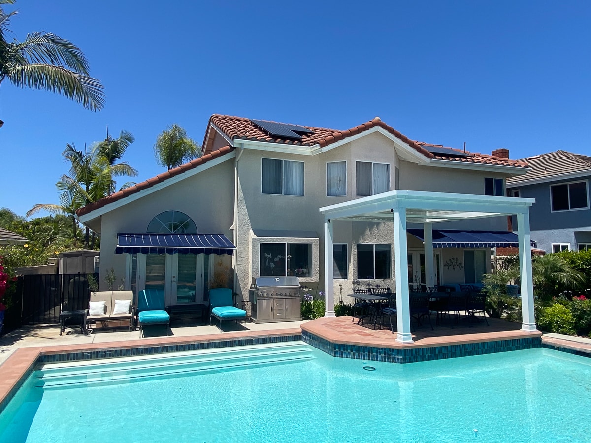 Outdoor environments under a pergola and next to a pool can't be beat.