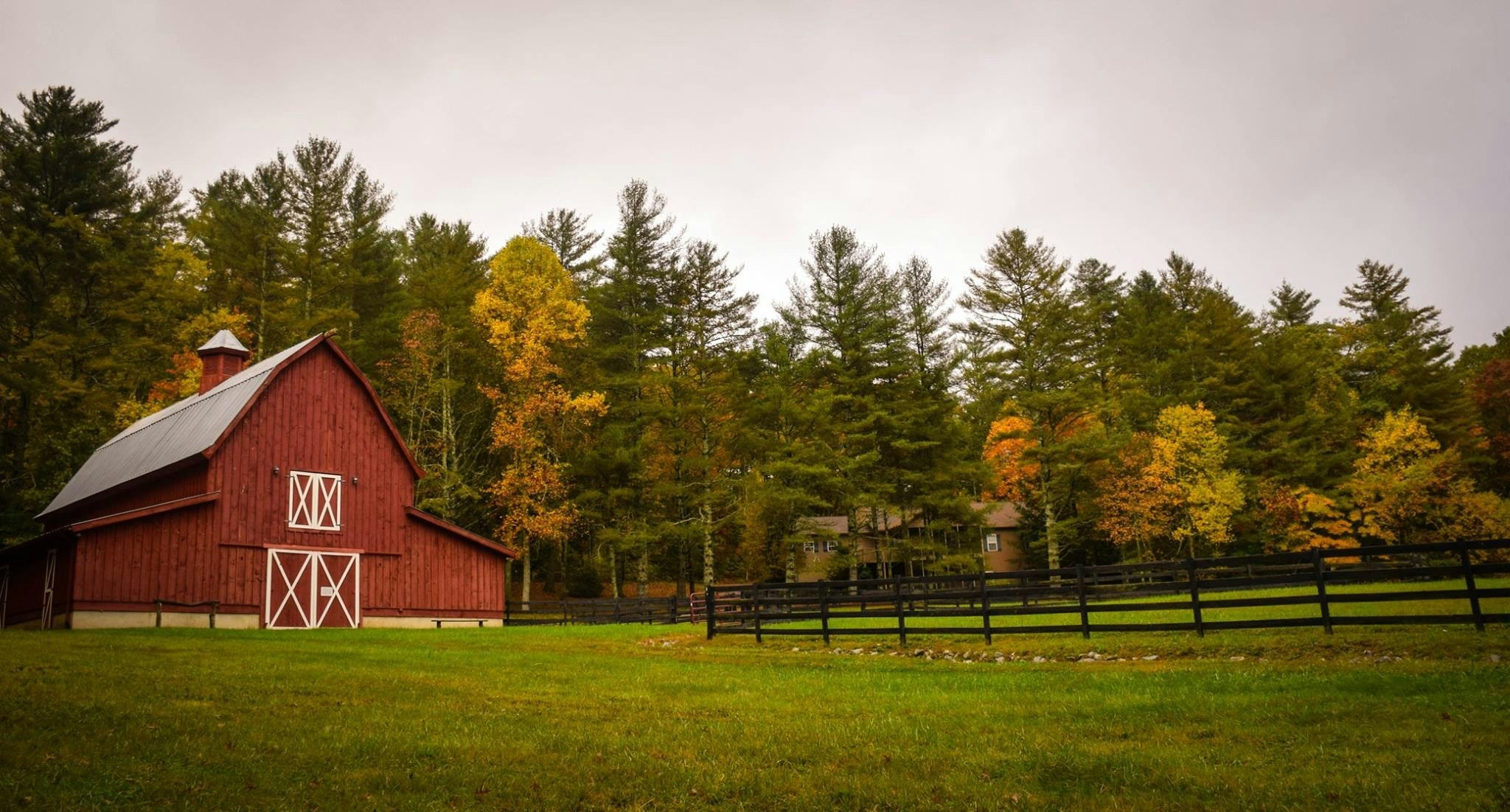 Farmland in rural part of America alongside a barn.