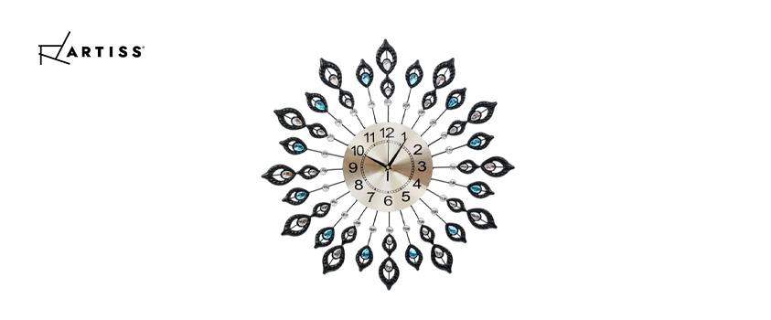 An Artiss modern crystal clock with an ornate peacock-style design.