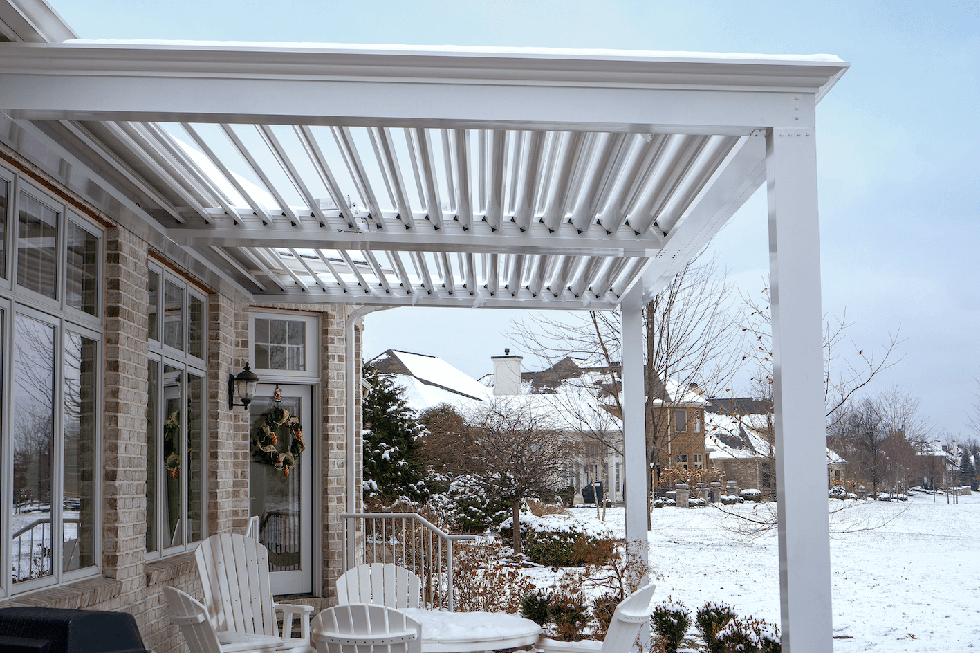 Snow on top of aluminum pergola with louvers roof on patio