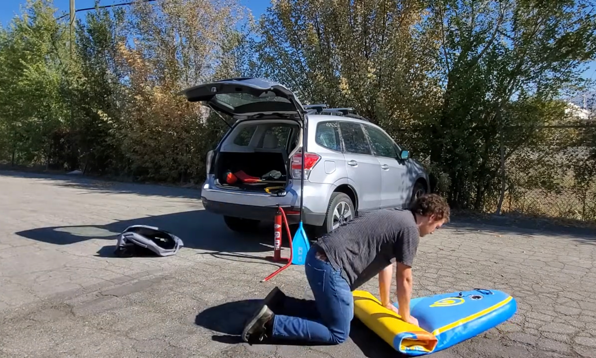 rolling up an inflatable sup board