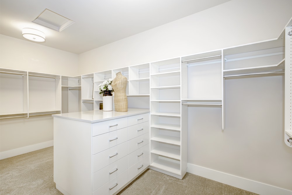 Spacious custom walk-in closet showing the best closet type for organized storage