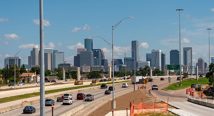  Heavy highway traffic approaching the Houston downtown skyline where car accidents frequently occur