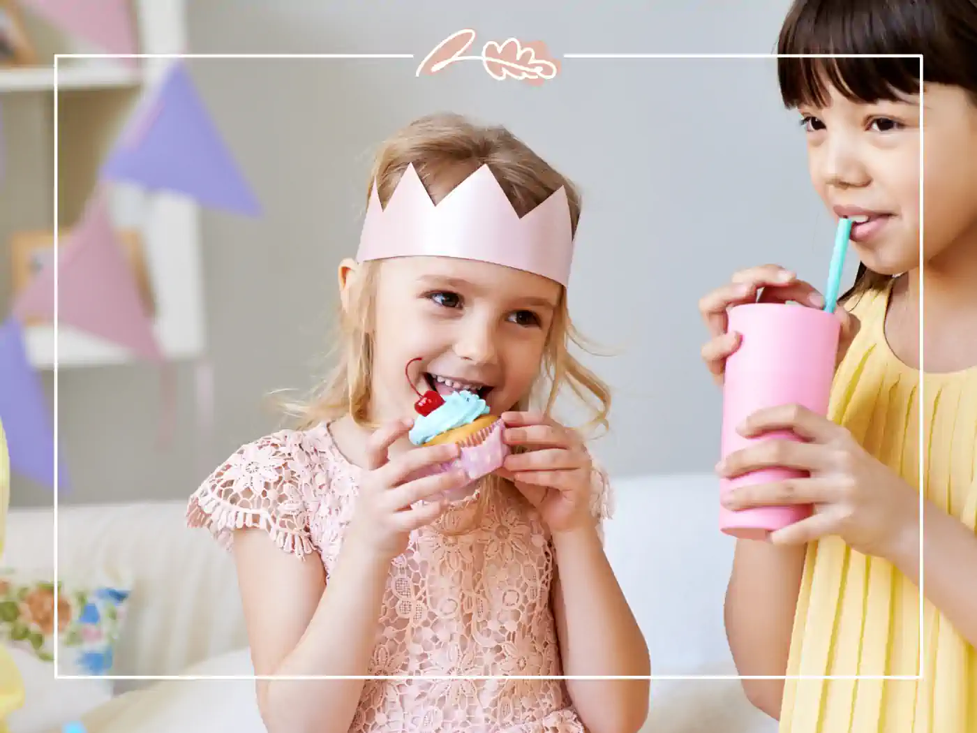 Two young girls enjoying cupcakes and drinks at a birthday party, one wearing a pink paper crown. Fabulous Flowers and Gifts - Birthday Collection.