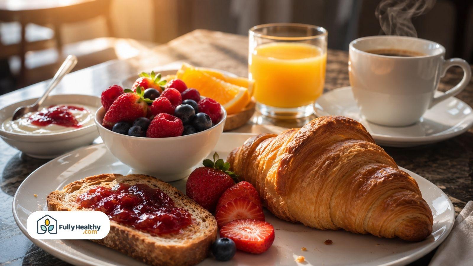 Continental breakfast with croissant fresh berries toast coffee and orange juice