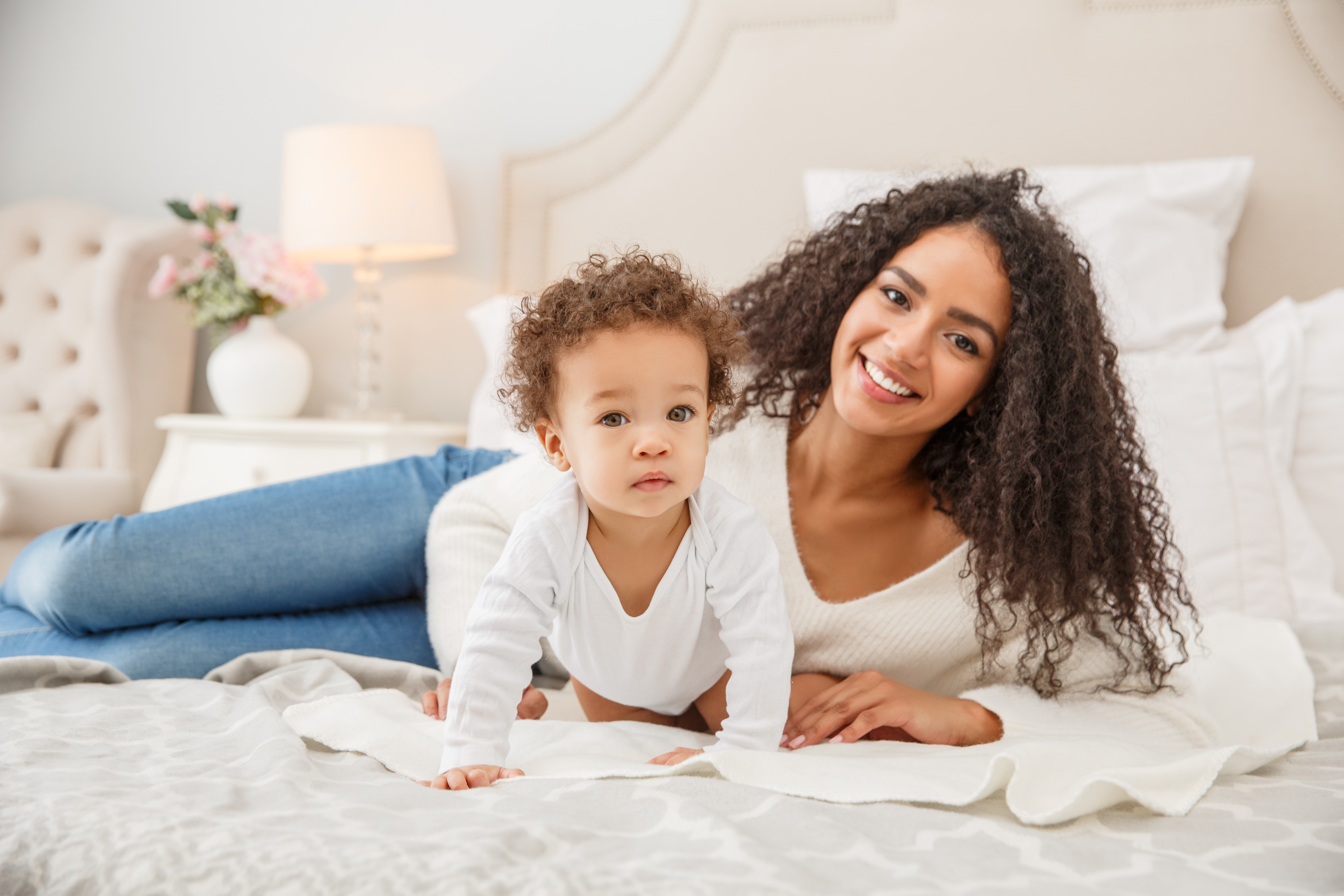Mixed Race Mom and Baby on bed