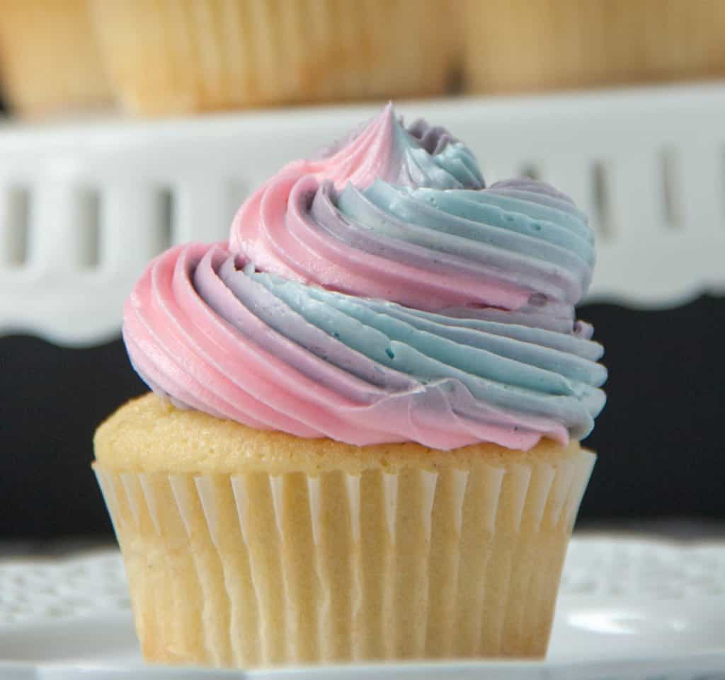 vanilla cupcake with rainbow swirled frosting