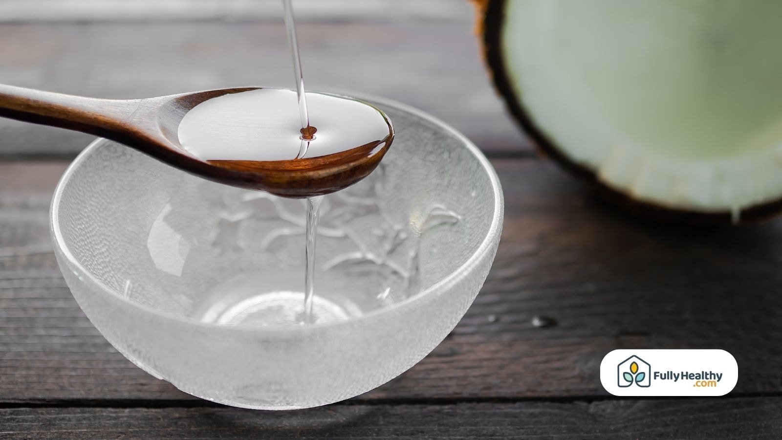 Coconut oil poured from wooden spoon into bowl
