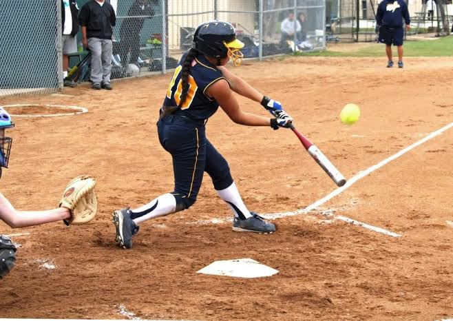 Softball player step forward for final down swing