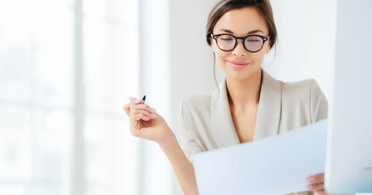 Woman reviewing an IRS lien release letter and Form 668-Z to confirm a federal tax lien was officially released.