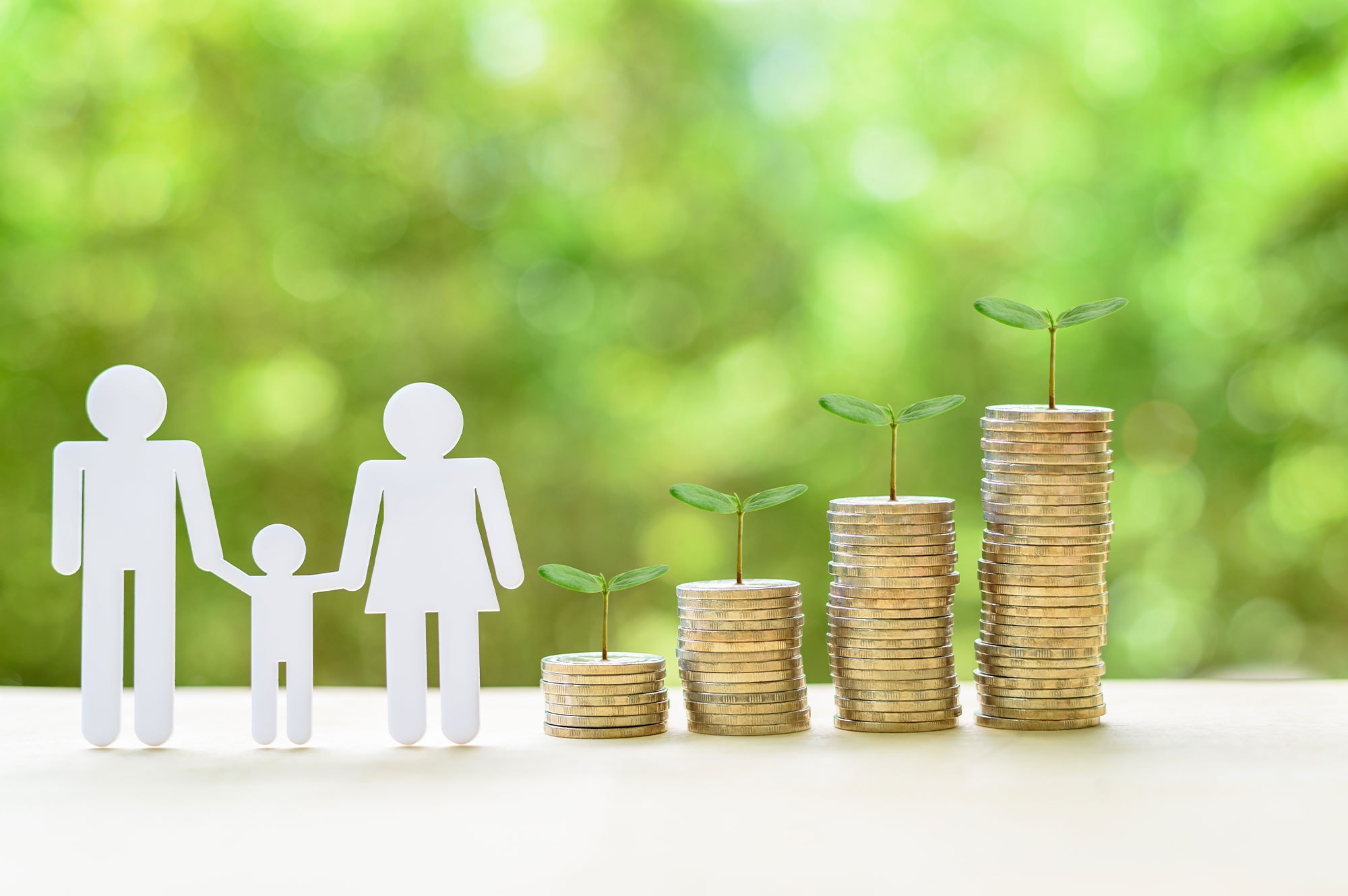 Paper cutout family beside stacked coins with growing plants, representing long-term wealth building through trusts