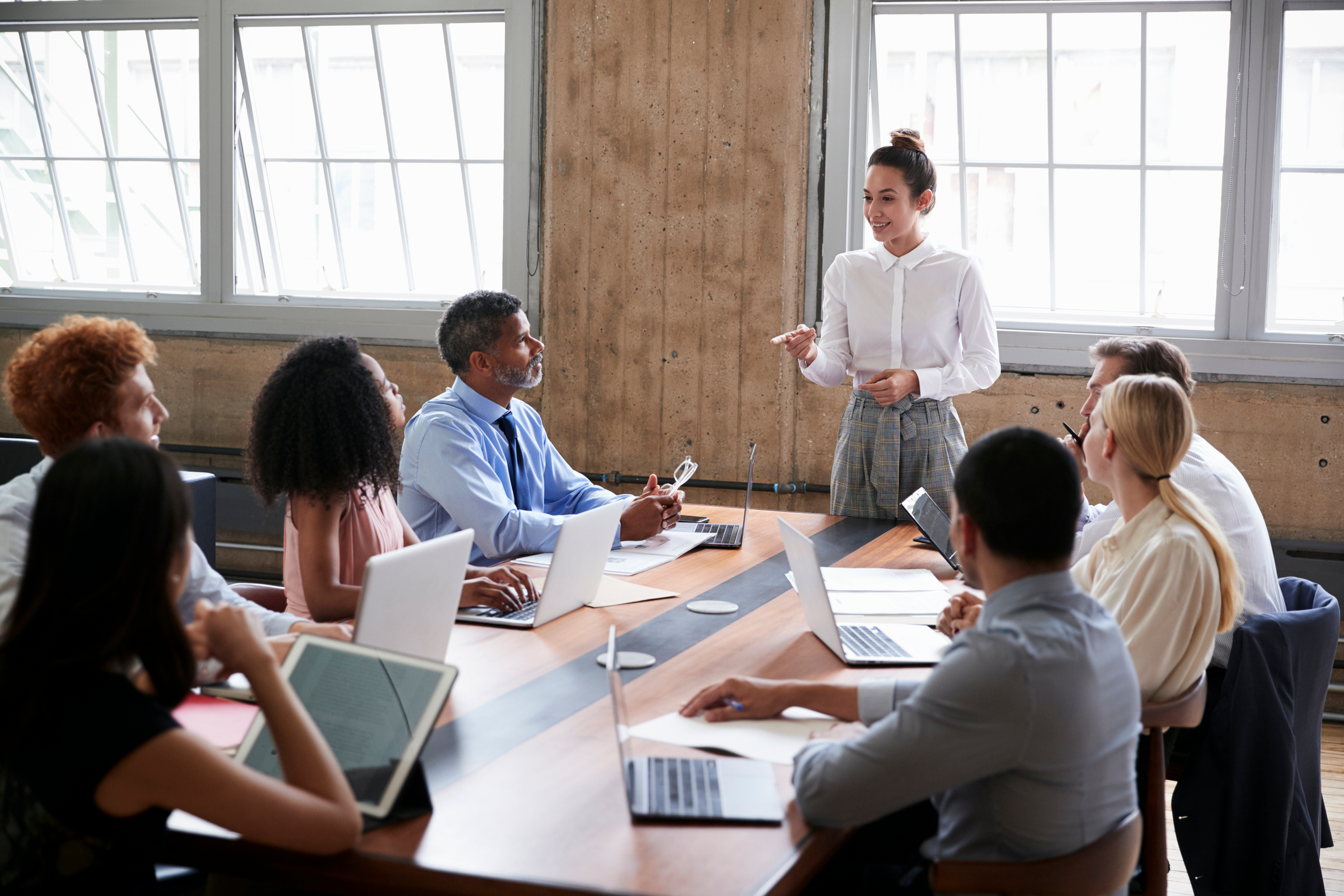 A person standing in front of a group of people, giving a speech about building a strong leadership foundation